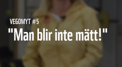 Suddig bild på kvinna i gul jacka. Vit text ovanpå: VEGOMYT #5 "Man blir inte mätt!"