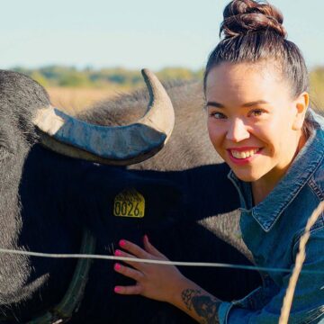 Julia står intill en vattenbuffel